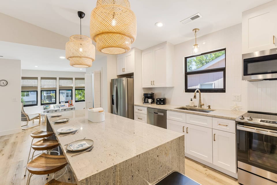 Kitchen with Stainless Steel Appliances, Stove, and Spacious Countertops for Easy Meal Preparation.