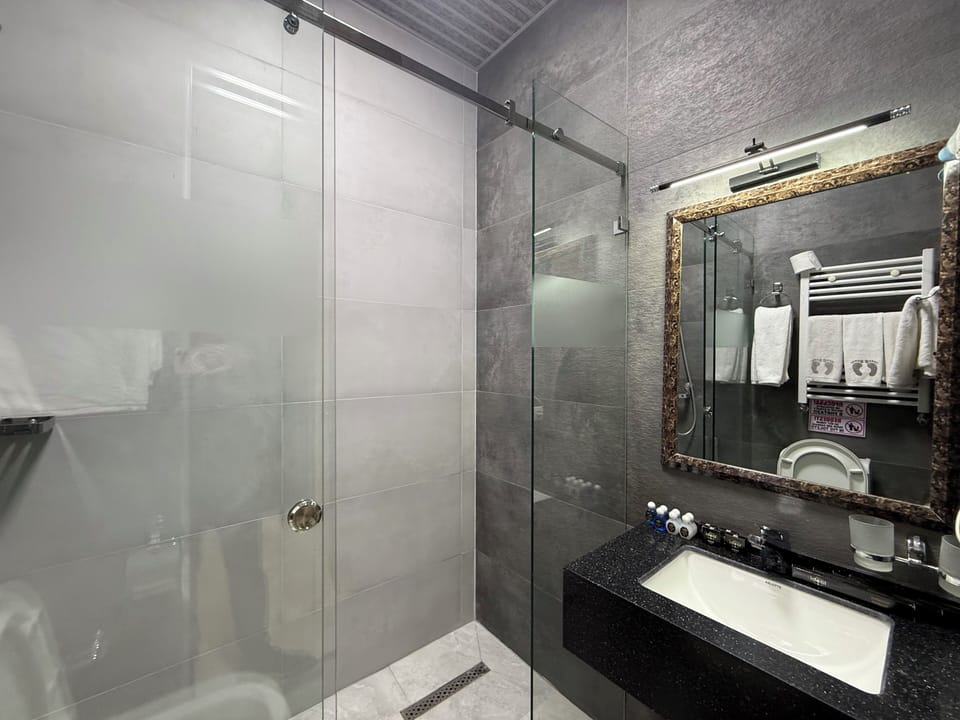 Superior Quadruple Room | Bathroom | Hair dryer, slippers, towels