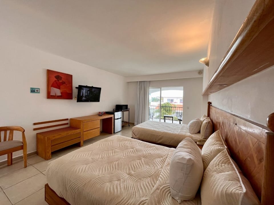  Room with two double beds with tv, fridge , microwave and coffe maker.