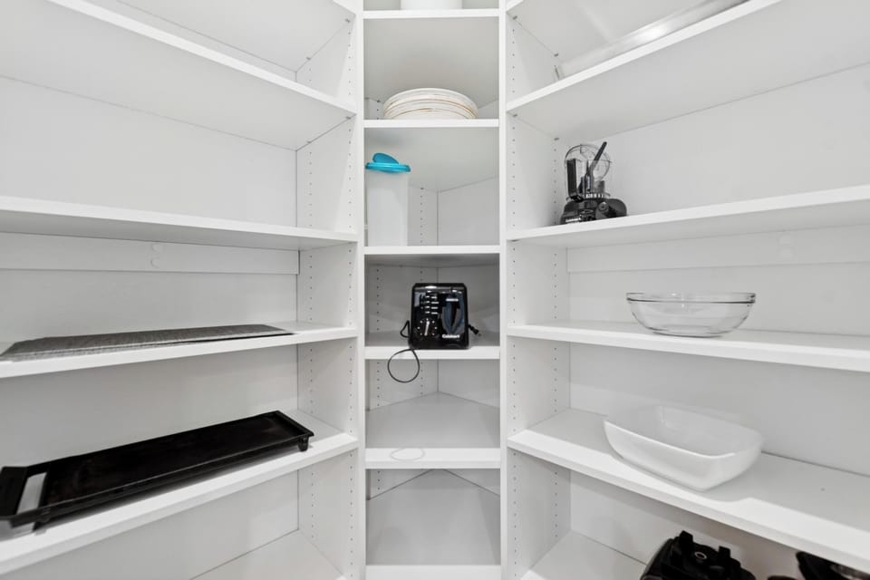 Your well-organized pantry keeps everything within reach, with spacious shelves for all your cooking essentials and serving pieces.