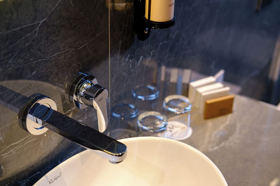 Shower, rainfall showerhead, hair dryer, towels