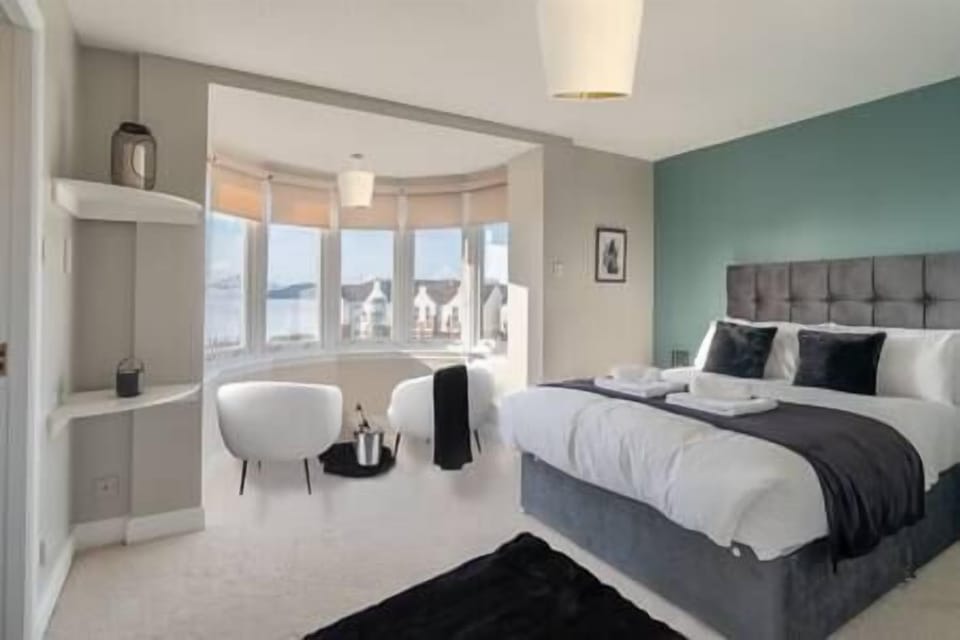 The master bedroom has breathtaking views out the 'bow window' of the Forth Bridges.