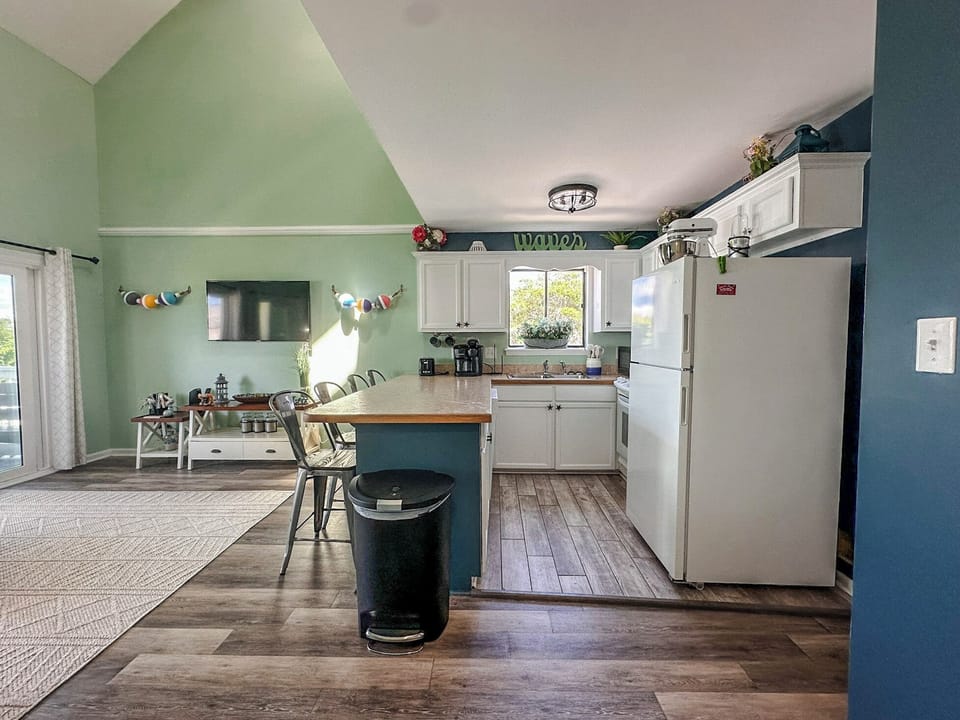 Step into your bright, cheerful kitchen where white cabinets and wood countertops create the perfect space for cooking memorable meals together.