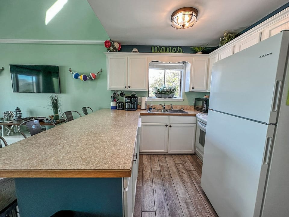 Your fully equipped kitchen awaits with modern appliances, granite counters, and everything you need to create memorable meals together.