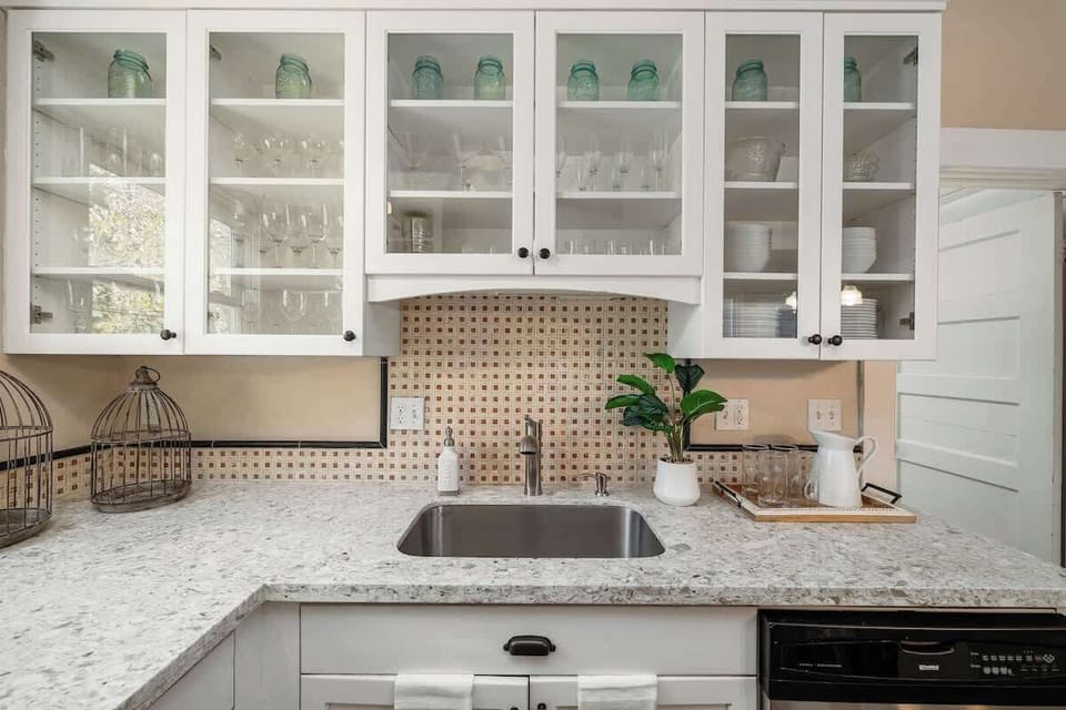 Kitchen sink with glass-front cabinets.