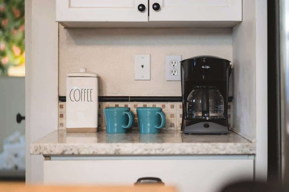 Kitchen coffee nook with mugs and drip coffee.