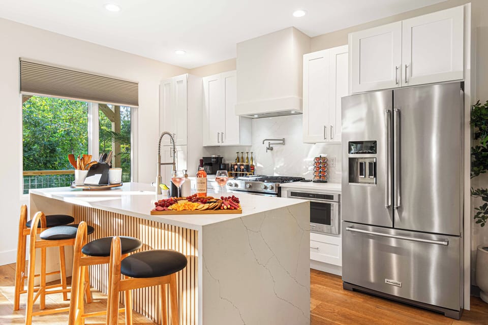 Enjoy cooking or chatting over coffee in this beautifully designed kitchen, complete with a spacious island and comfortable counter stools
