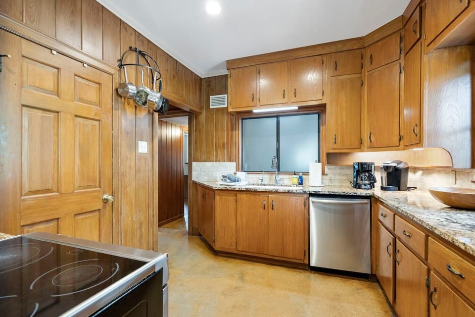 Kitchen with full pantry in the left hand door with spices and other supplies.