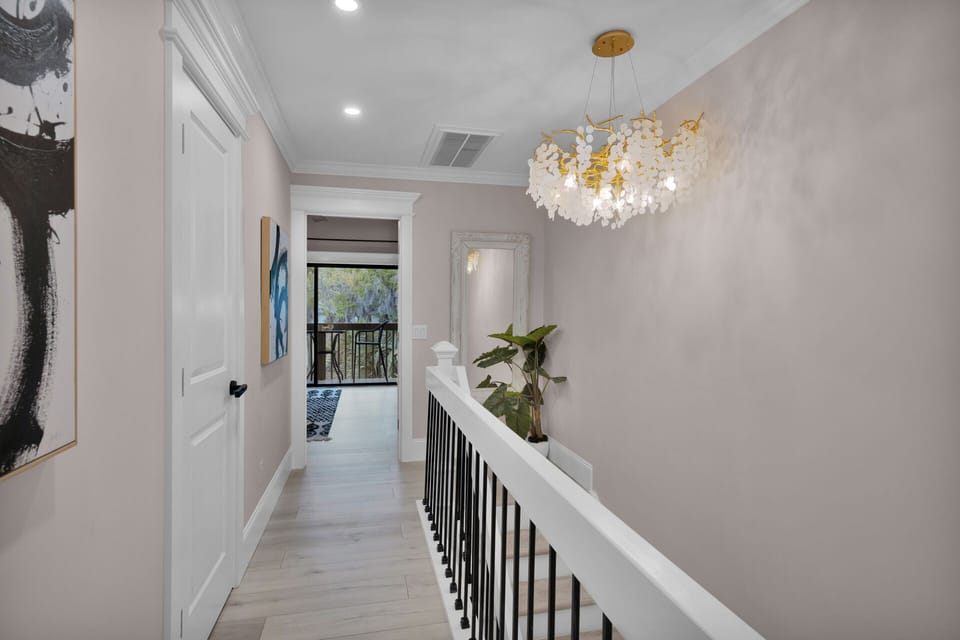 Second-floor hallway. Step upstairs to a beautifully lit hallway, where serenity meets sophistication—your peaceful retreat awaits.