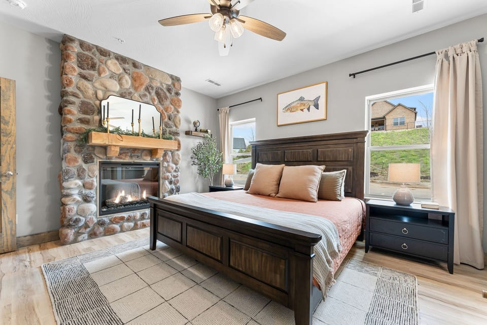 [Bedroom 1] Sleep peacefully in this well-appointed main level bedroom, offering a king bed, fireplace, and attached ensuite bathroom.