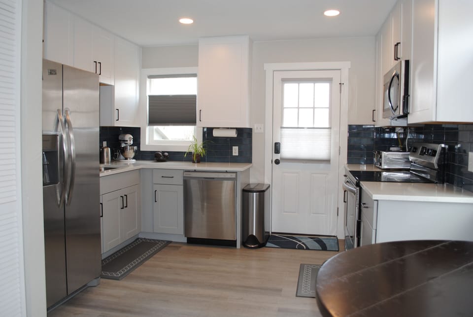 Full kitchen with stainless steel appliances.