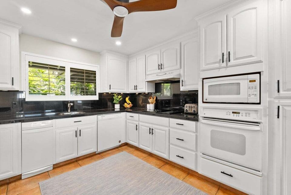 Spacious kitchen with natural light, elegant cabinetry, and a full suite of appliances for easy meal prep