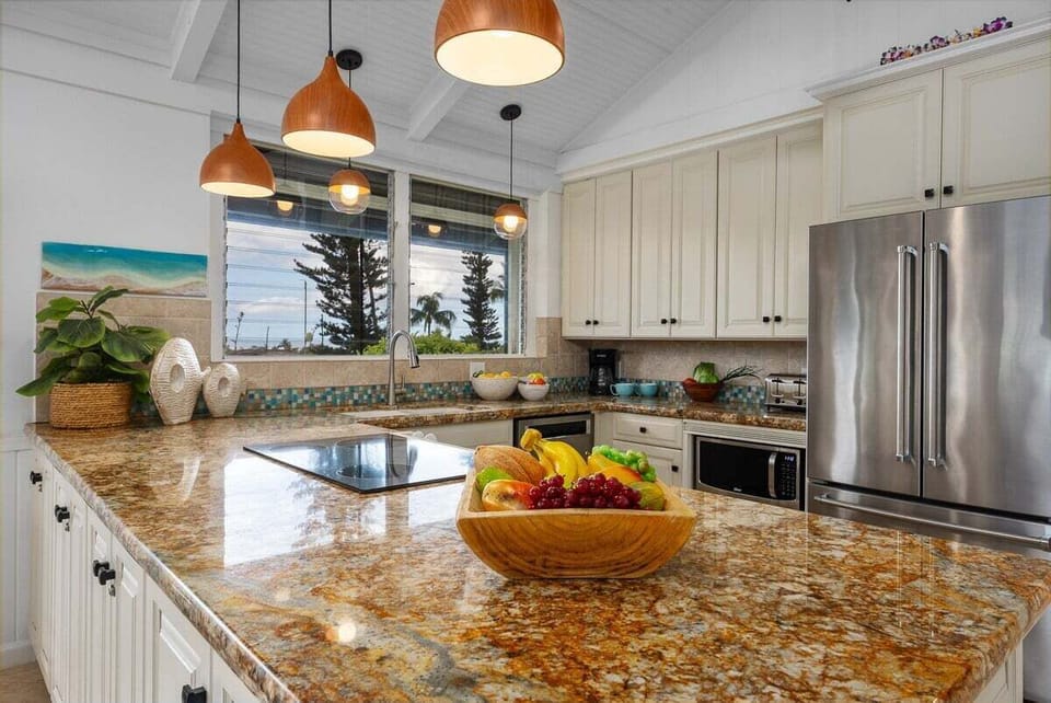 Prepare meals in style with granite countertops, stainless steel appliances, and warm lighting that enhances the inviting atmosphere