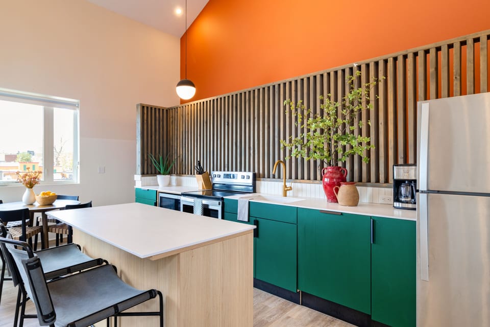 Modern kitchen features stainless steel appliances.