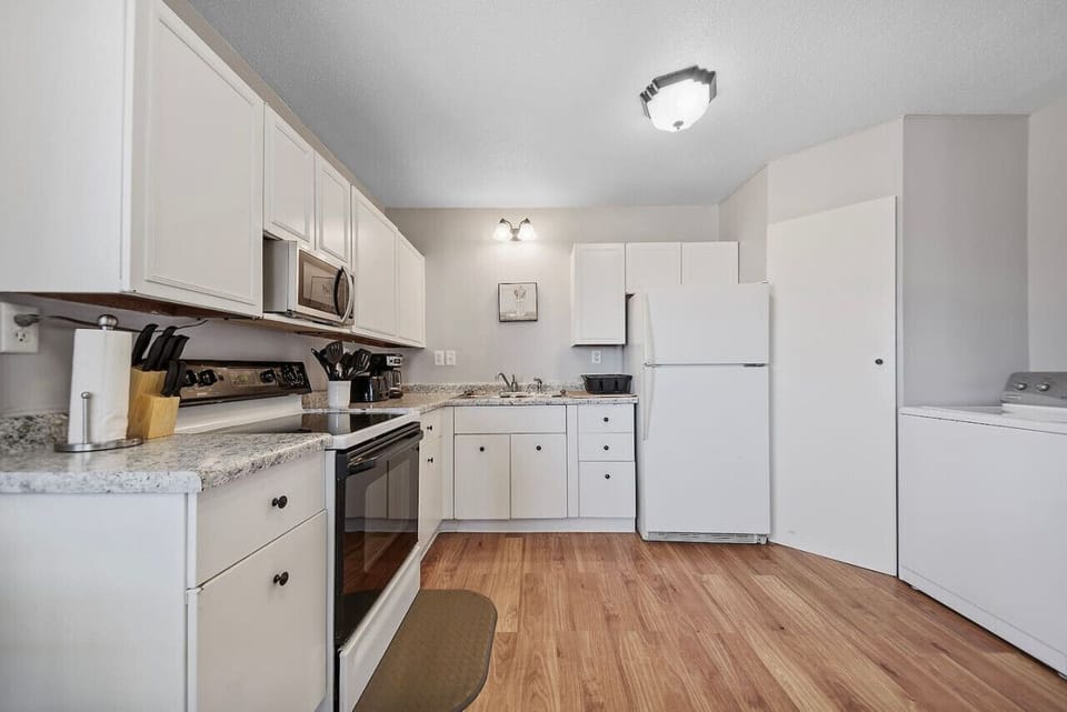Fully-stocked kitchen equipped with modern appliances and ample supplies, ensuring convenience and ease for all culinary endeavors.