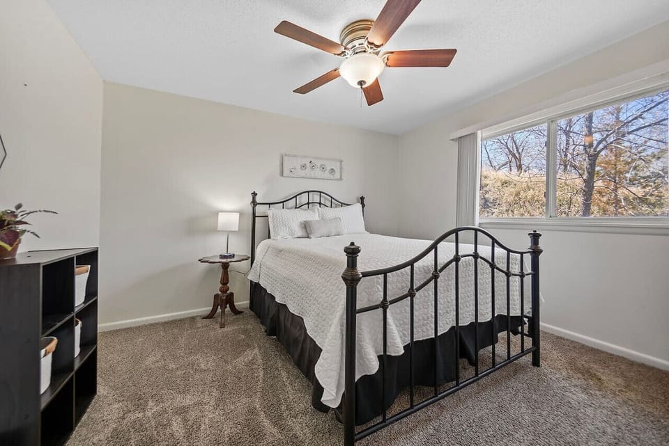 A serene queen bedroom with scenic views of the outdoors, providing a tranquil retreat for restful nights and peaceful mornings.