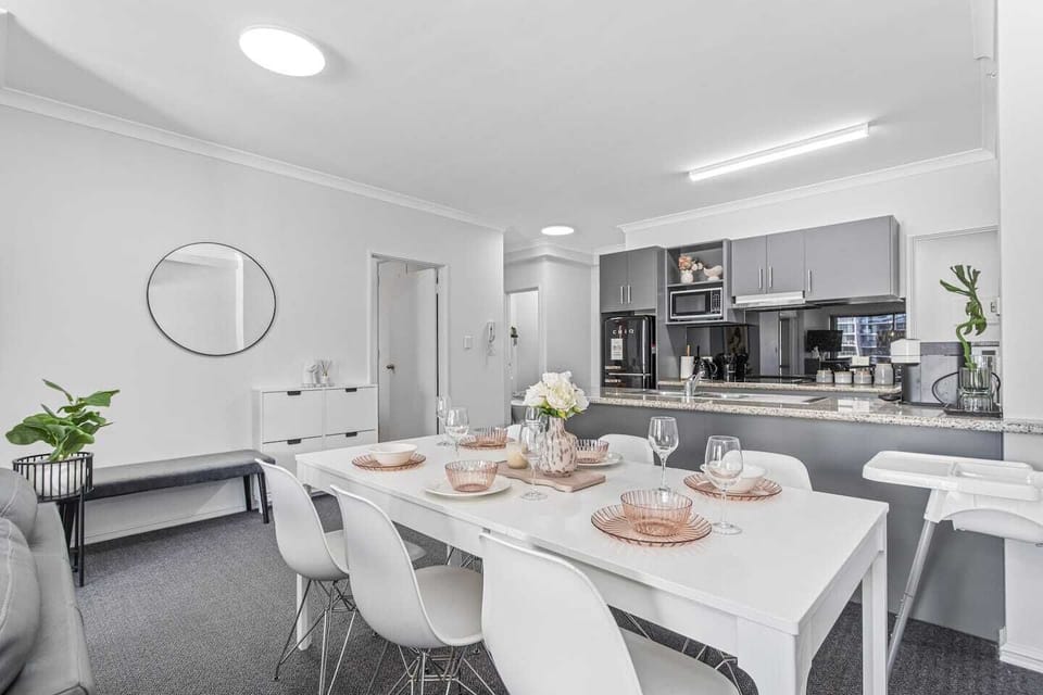 Spacious dining area adjacent to a modern kitchen, perfect for comfortable living.