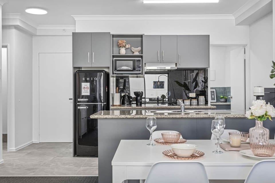 Efficiently designed kitchen with ample storage, a breakfast bar, and essential appliances, seamlessly connecting to the dining area.
