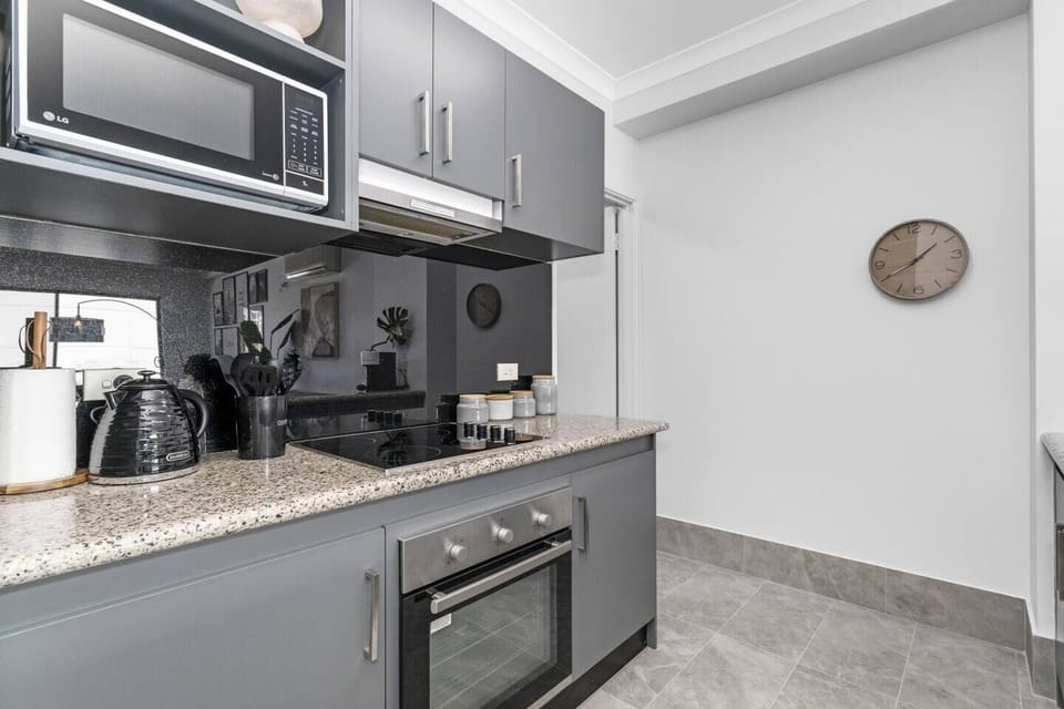 Compact and efficient kitchen, perfect for meal preparation, complete with a built-in oven, stovetop, and microwave.