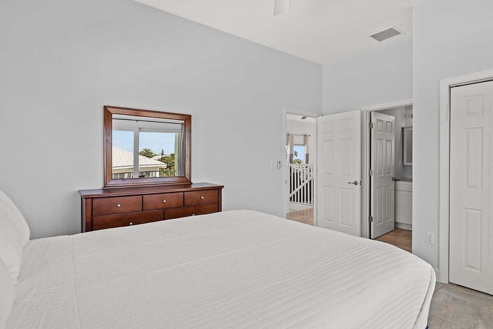 2nd 3rd level master bedroom with ensuite bathroom and direct access to balcony overlooking pool, canal, and views of the Atlantic.