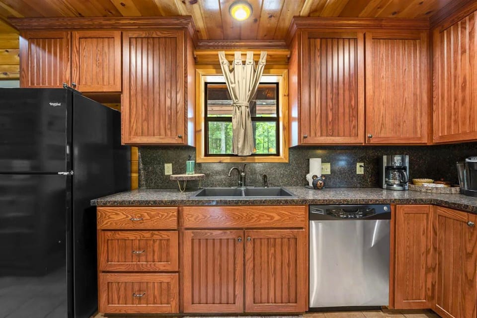 Enjoy the best of both worlds in this kitchen, featuring beautiful wood accents and state-of-the-art appliances. It's a chef's dream come true.