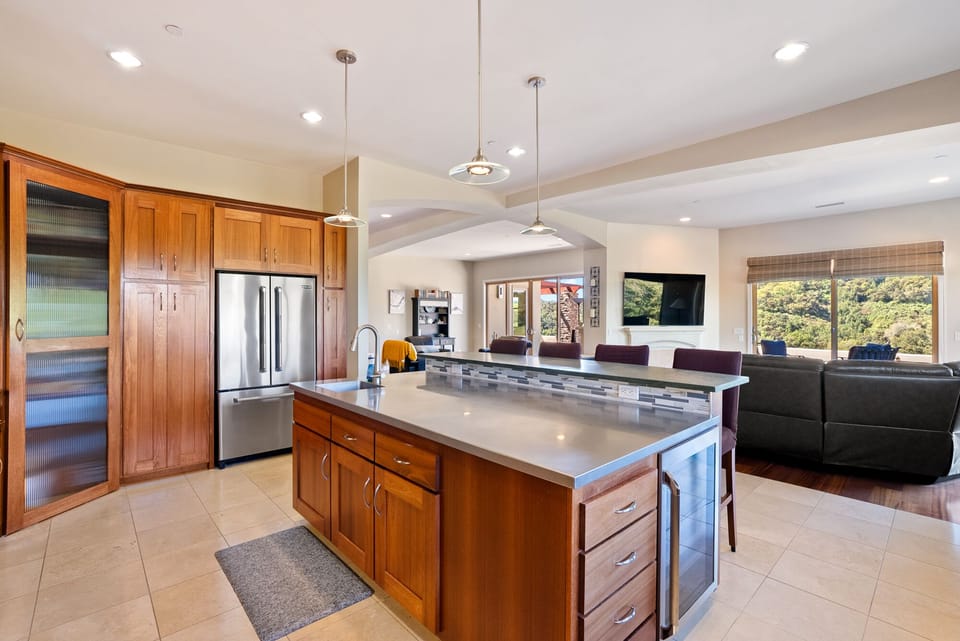 This gourmet kitchen features high-end stainless steel double ovens built into custom wood cabinetry. It is a perfect space for culinary mastery.