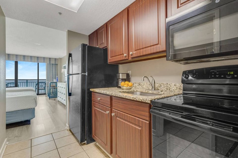 The cozy layout seamlessly connects the suite and kitchen, where modern appliances await your culinary creations.