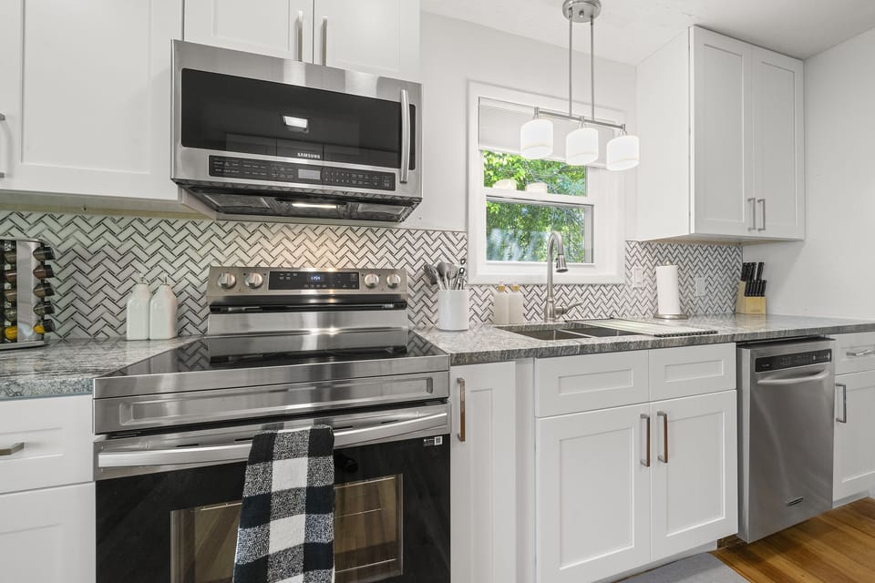 Cottage A- All brand new appliances accompanied by white cabinets and drawers.