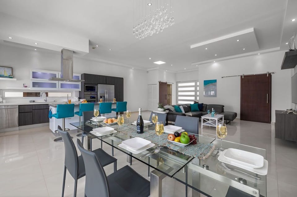 Experience ultimate comfort in the inviting living and dining area, where open space beckons you to unwind while soaking in the picturesque view of the pool area.