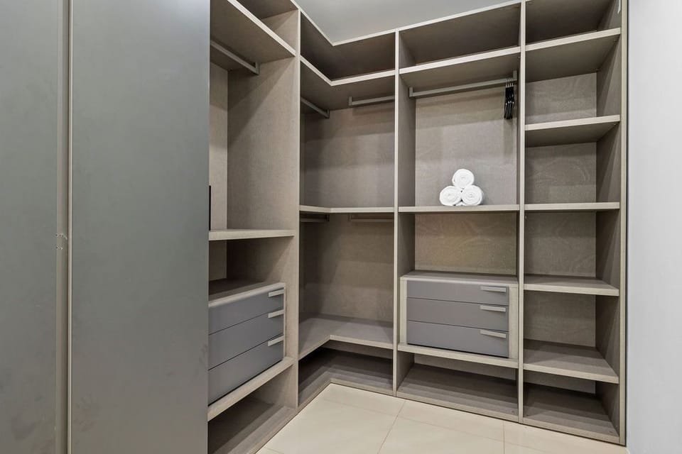 Indulge in luxury and convenience with our spacious walk-in closet, offering ample storage space for your belongings and ensuring that you have everything you need for a comfortable and organized stay.