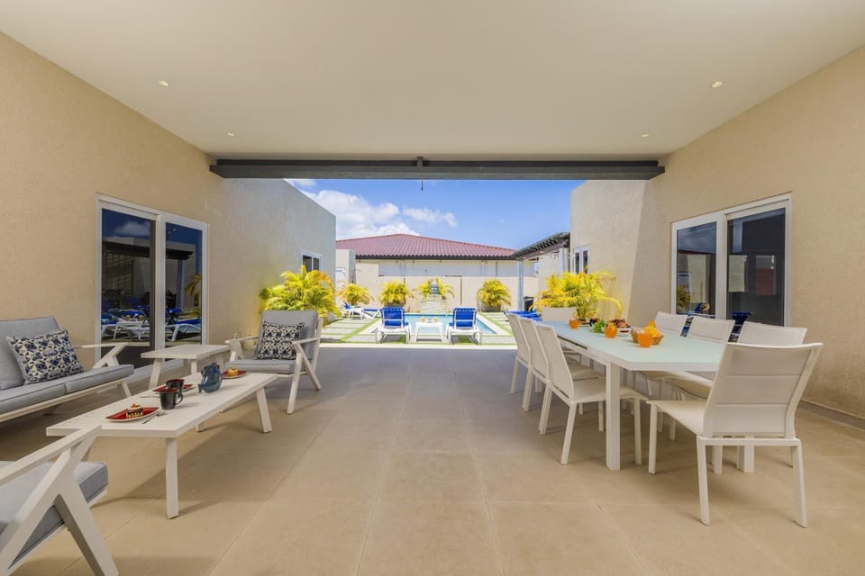 Relax on the patio and enjoy pool views. Table and chairs for dining al fresco.