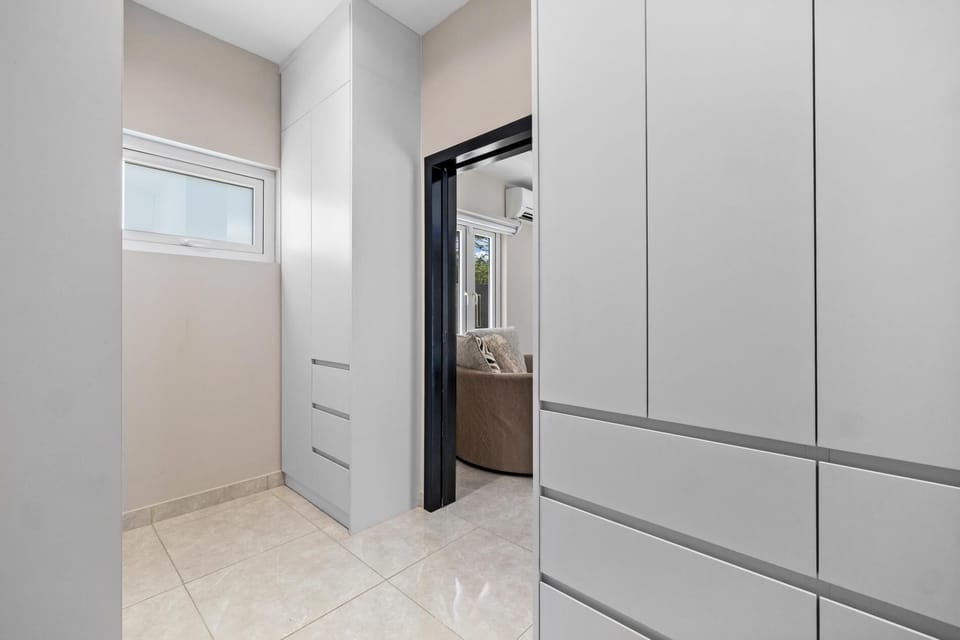 Spacious walk-in closet with drawers.