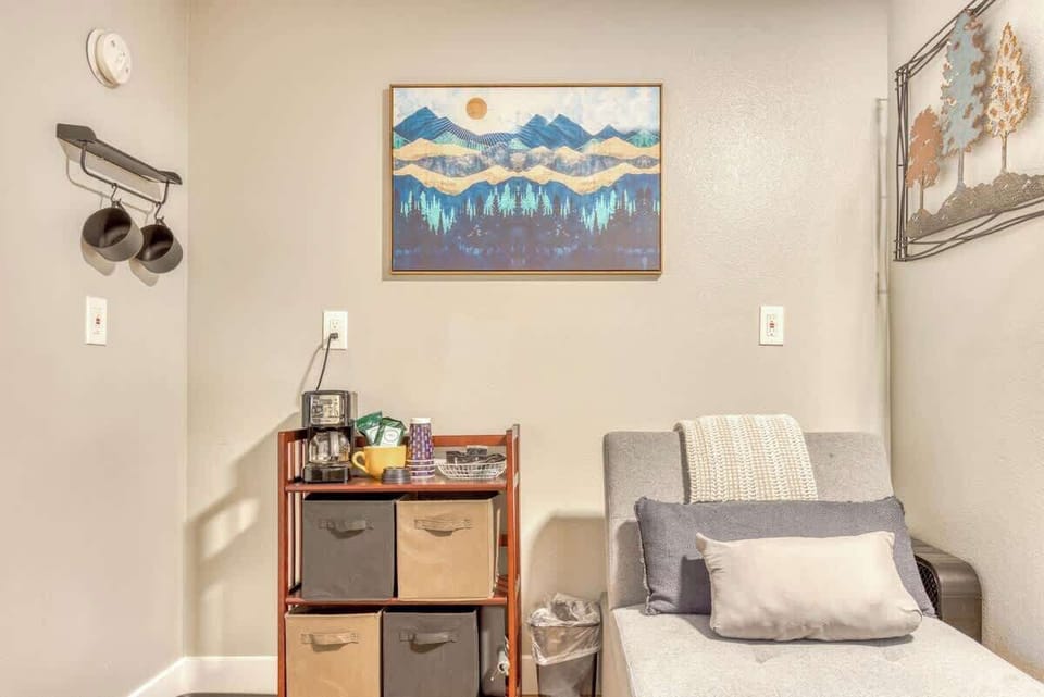 Unique & organized nook! Discover this charming corner with artistic touches & practical storage. 