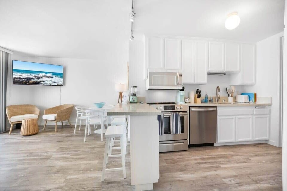 View as you walk in from the front door. Kitchen has all essentials needed for a comfortable stay. Keurig shown has been replaced with a drip coffee machine. 