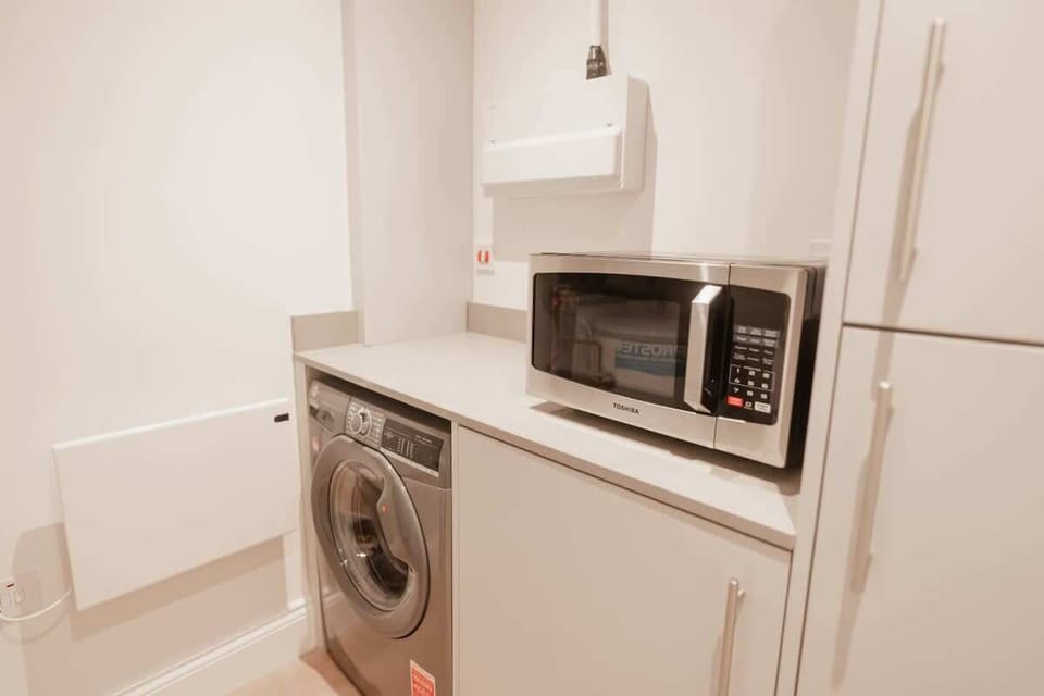 The Open Plan Living Space: with all amenities including a washing machine and microwave, you will feel right at home here.