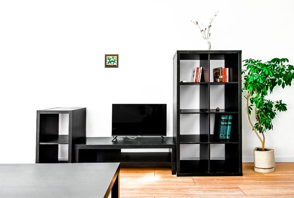 Entertainment area with TV and storage for relaxing evenings.
Book now and enjoy cozy nights in.