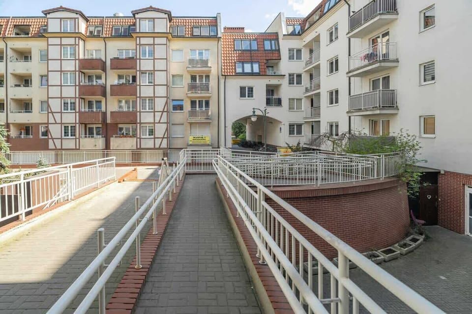  A courtyard between buildings with pathways and greenery.