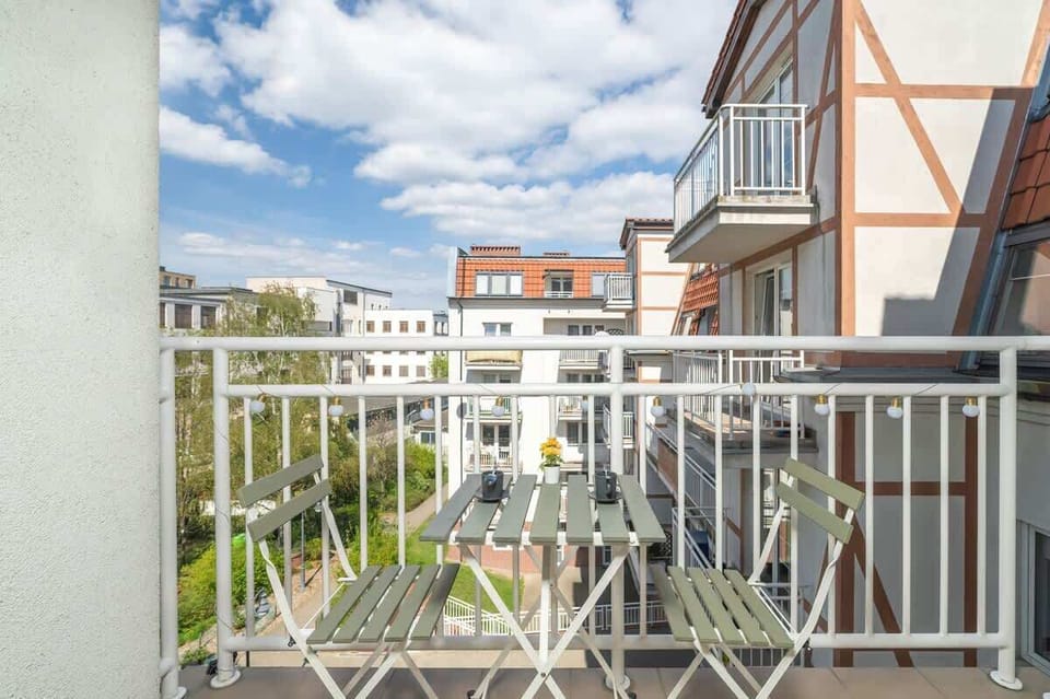 Balcony with a metal railing and a view of nearby buildings.