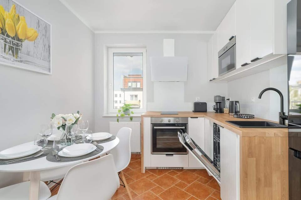A view of the kitchen with a dining area, showing the counter space, refrigerator, and dining table.