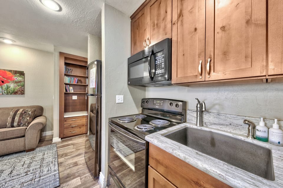Your fully equipped kitchen features warm wood cabinets, granite counters, and all appliances you need for home-cooked meals.