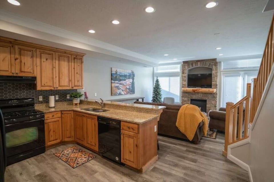 The open-concept living space, complete with a counter dining area, facilitates effortless conversation with family and friends.