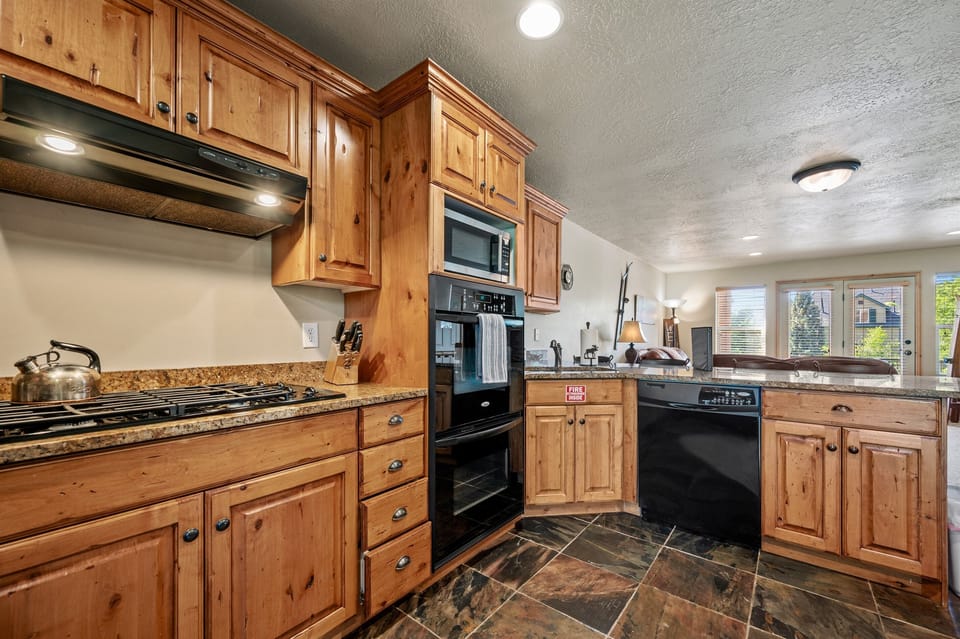 a double oven and large gas stove makes it easy to cook family meals.