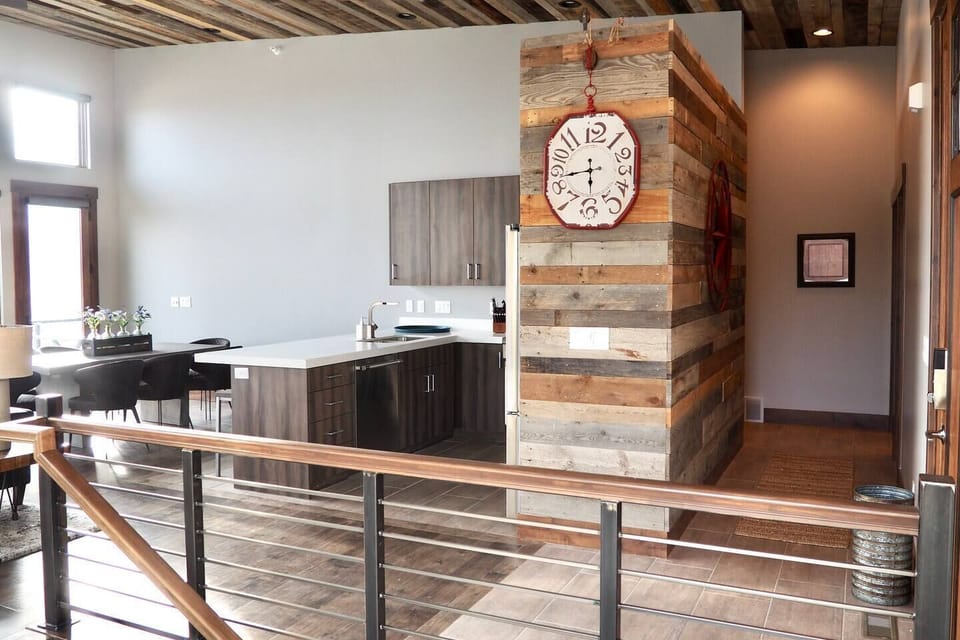 With its modern lighting, windows, quartz countertops, and stunning backsplash, the kitchen makes preparing dinner a truly enjoyable experience.