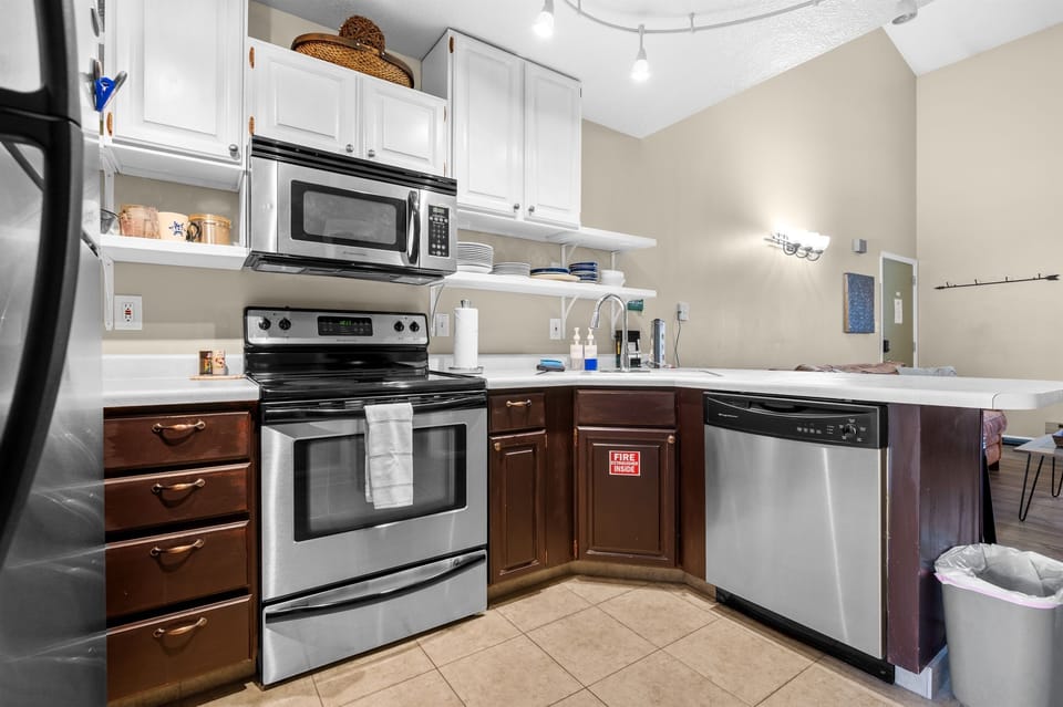 Modern kitchen with microwave, dishwasher, and plenty of counter space for cooking and entertaining.