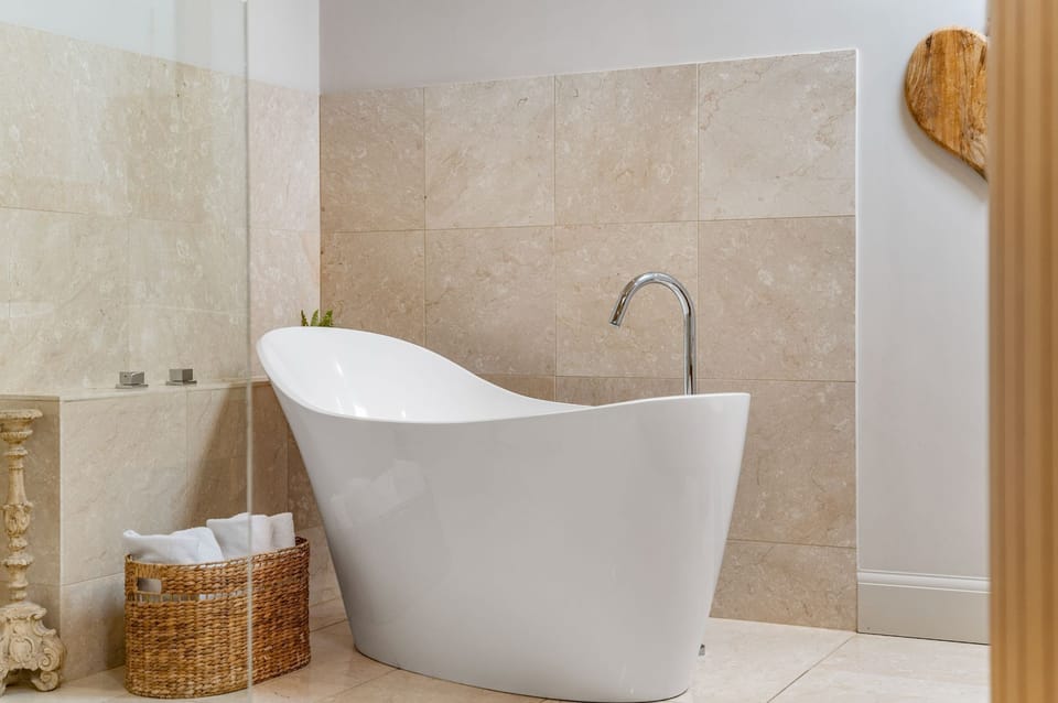 Indulgent freestanding bath at Dexter, in a bright and tranquil setting.