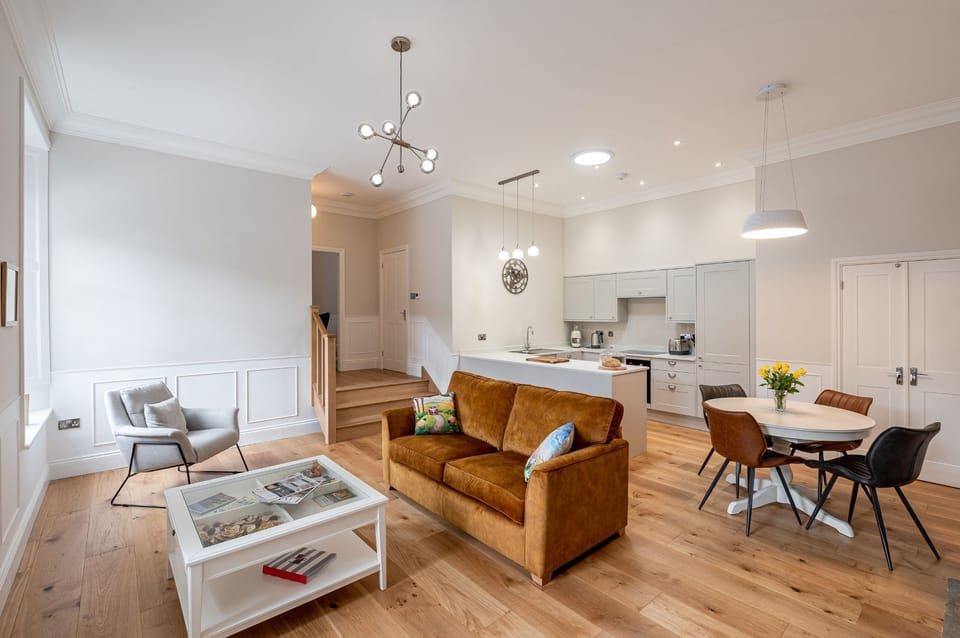 The Wensleydale spacious open-plan living area with lounge seating, dining table and modern kitchen with breakfast bar.