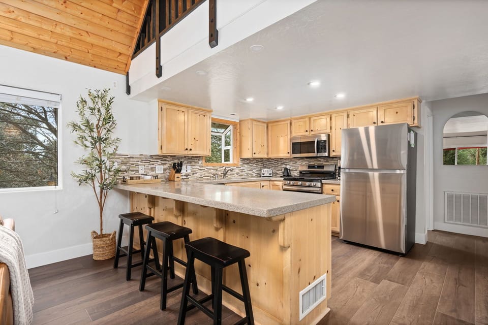 Full Kitchen with All New Appliances, stocked with an abundance of cookware for your culinary creativity.  Counter stools make for quick and casual seating options.