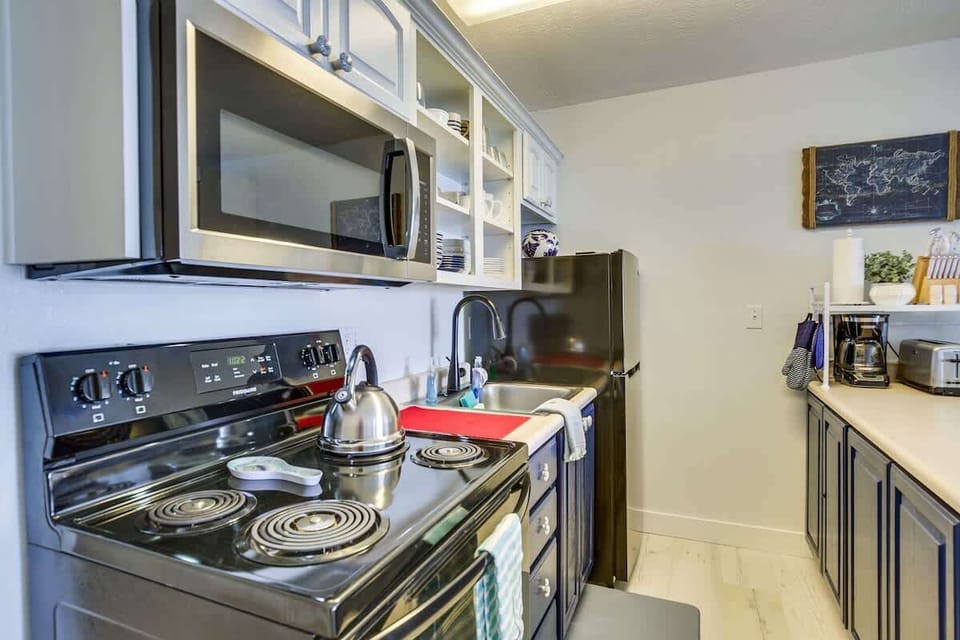 The kitchen has full-size appliances including a stove, oven, and fridge