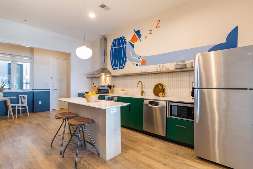 Fully equipped kitchen boasts stainless steel appliances.