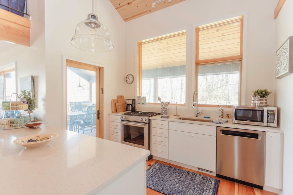 Kitchen area with views of screened porch and backyard